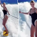 Ivanka Trump shows off her figure in plunging black swimsuit while surfing on family vacation